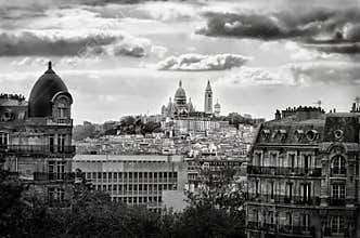 View of Sacre-Coeur Basilica in Paris taken during cloudy weather showing buildings and landmarks in the cityscape