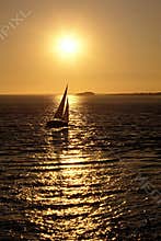 Sailing in Bretagne at sunset with the sun reflecting on the water