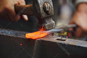 Forging hot iron