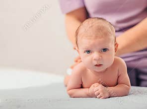 A healthcare provider cares for a newborn baby during a routine examination