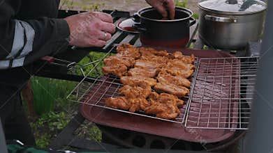 Hands with Vitiligo Arranging Marinated Meat on Barbecue Grill Rack