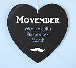 Movember fundraising for mens health awareness message on blackboard