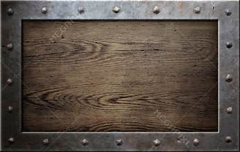 Old metal frame over wooden background