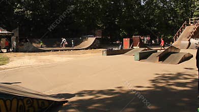Teens practicing skateboard