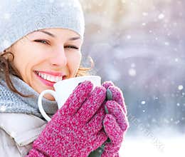 Winter woman with hot drink outdoors