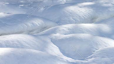 Exploration of snow forms showing curves and textures in a winter landscape during bright daylight hours