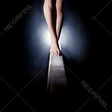 Feet of gymnast on balance beam