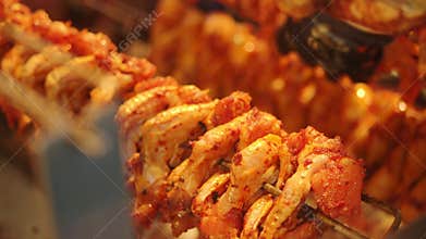 Marinated Chicken Wings Roasting on a Rotisserie Skewer