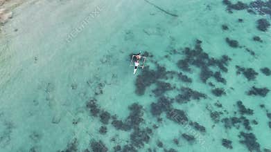 POI drone shot of two local fishermen casting a net from a small boat