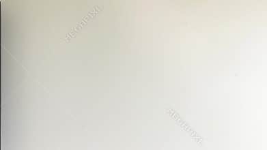 Person in a white t-shirt walks past a plain