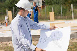 Young architect checking a structural drawing