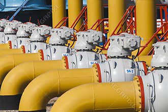 Pipes and valves are on the gas compressor station