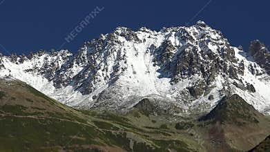 Patagonia Argentina snowy mountain peaks rise above rugged terrain under soft daylight, mountains, andes, south america, andean