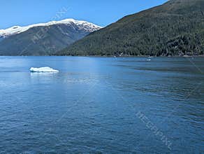 Beautiful alaskan landscape with floating glacier ice and snow peaks