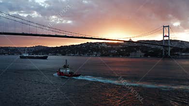 Tugboat sailing on Bosphorus strait at sunrise in Istanbul