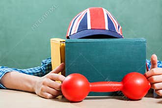 Funny schoolboy wearing baseball cap learning