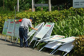 Shenzhen, China: a security guard in the removal of advertising signs
