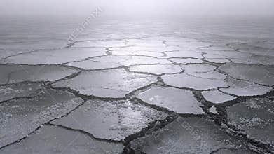 Frozen ocean surface with cracked ice floes