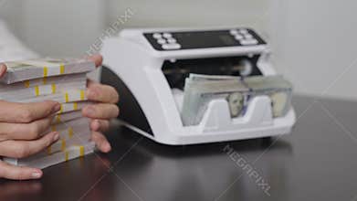 Hands counting money machine in office. Handling finance and cash. Businessman counting dollars close-up. Banker counting money