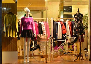 Store display window Light and decorative bike, Fashion boutique display window with mannequins, store sale window, front of shop