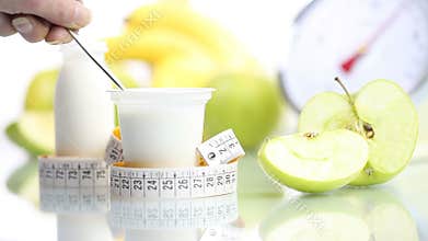 Diet food teaspoon blending yogurt fruit Apple meter and scales balance