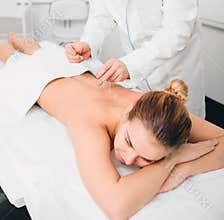 Client having acupuncture treatment on her back