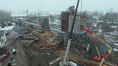 Construction Demolition Work on Grain Silo Structure Takes Place in Winter Time
