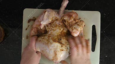 horizontal video of fresh chicken being marinated for baking in the oven.