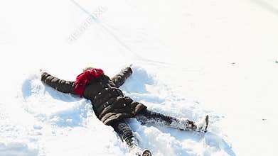 Little girl making snowangel