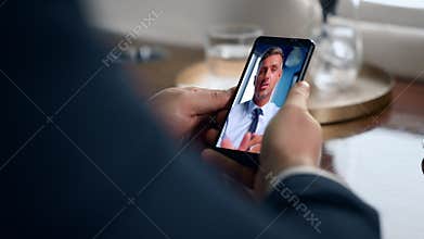 Banker video call mobile phone discussing investment close up. Videoconference