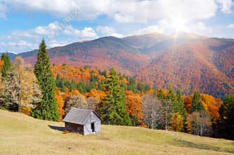 Hut in a mountain forest. Autumn Landscape