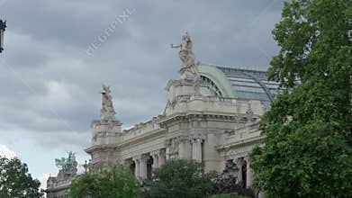 Grand Palais historic facade with sculptures and glass roof dome in Paris