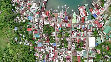 Push-in Bird-eye view from high altitude over a coastal shanty town in the Philippines. Th