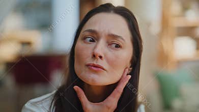 Closeup lady examining face wrinkles age-related changes looking home mirror.