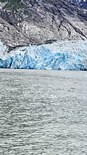 Endicott Arm, Alaska Fjord water icebergs and black sun glowing  mountains at the Fjord of Endicott Arm
