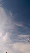 Blue sky with wispy cirrus clouds and copy space, clean background texture