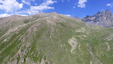 Aerial Kackar Mountains Turkey valley stream and green meadows open across treeless alpine terrain, water, rocks, creek, turkiye