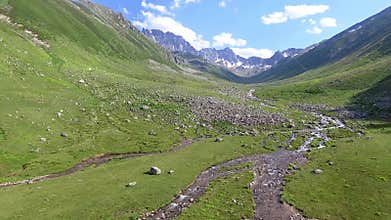 Aerial Kackar Mountains Turkey valley stream and green meadows open across treeless alpine terrain, water, rocks, creek, turkiye
