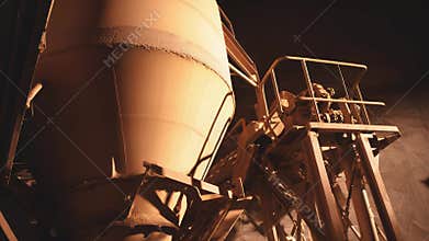 Industrial silo processing material inside factory building