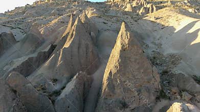 Aerial drone view of Cappadocia fairy chimneys and sculpted volcanic valleys in Turkiye, rock formations, badlands, volcanic tuff