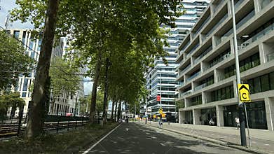 Tree lined business street beside modern office towers in Amsterdam Zuidas