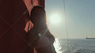 Beautiful girls in bikini relaxing on a yacht in