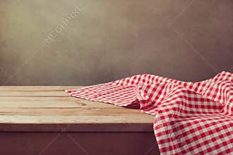 Empty wooden deck table with checked tablecloth for product montage display