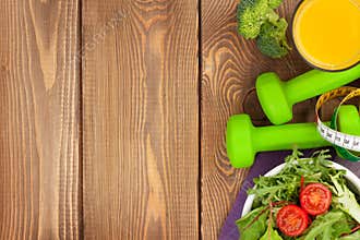 Dumbells, tape measure and healthy food. Fitness and health