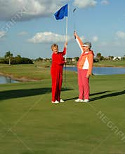 Happy lady golfers celebrate