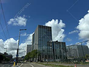 Modern office towers rise above wide urban road in Amsterdam Zuid, with