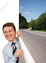 Smiling business man holding a image