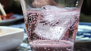 Close-up view of effervescence from a glass of Pink Lemonade Soda