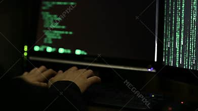 Professional hacker working at night, trying to break into system, cybercrime