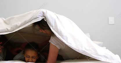 Family having fun in bedroom